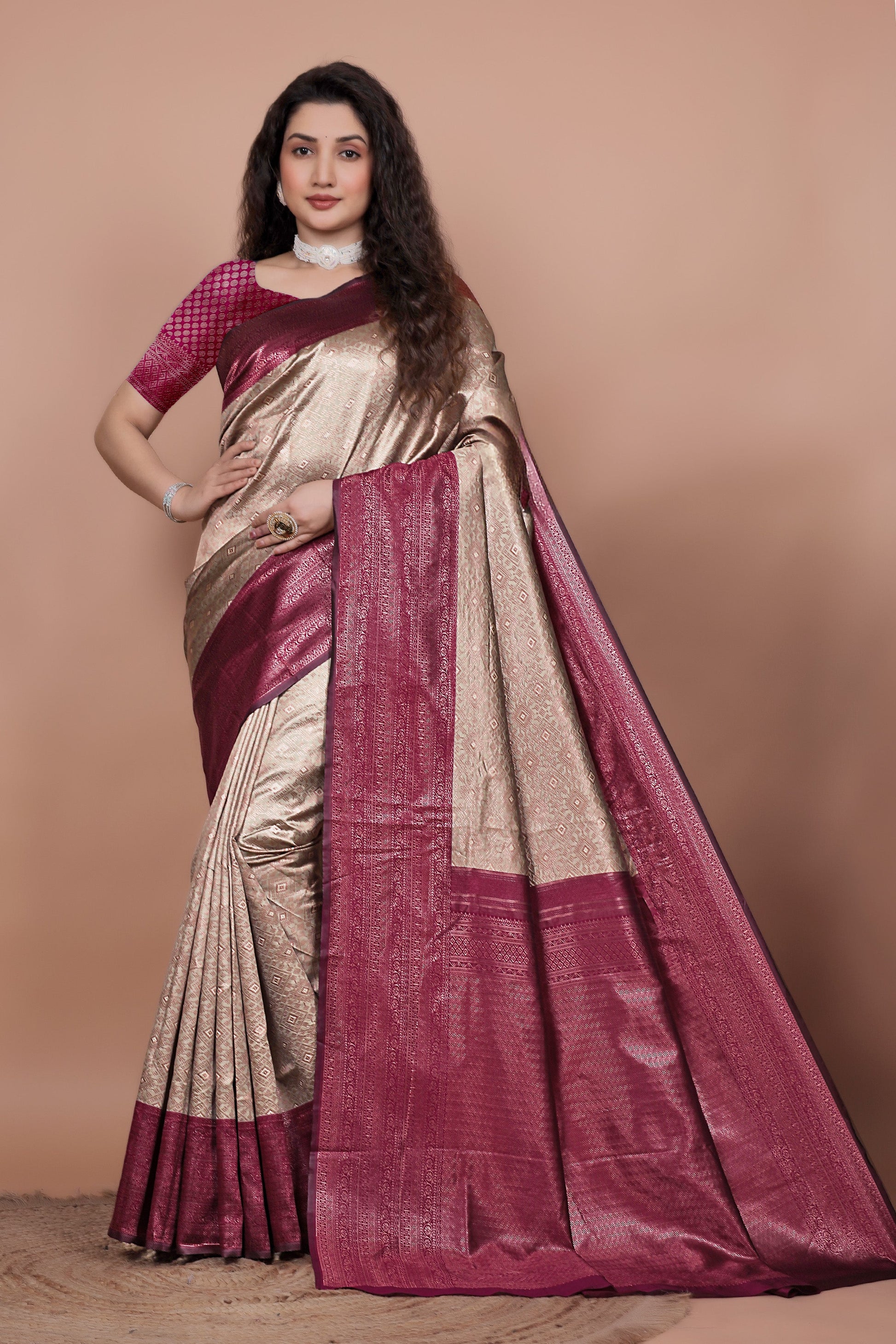 Model posing in a chikoo and cherry woven jacquard silk saree